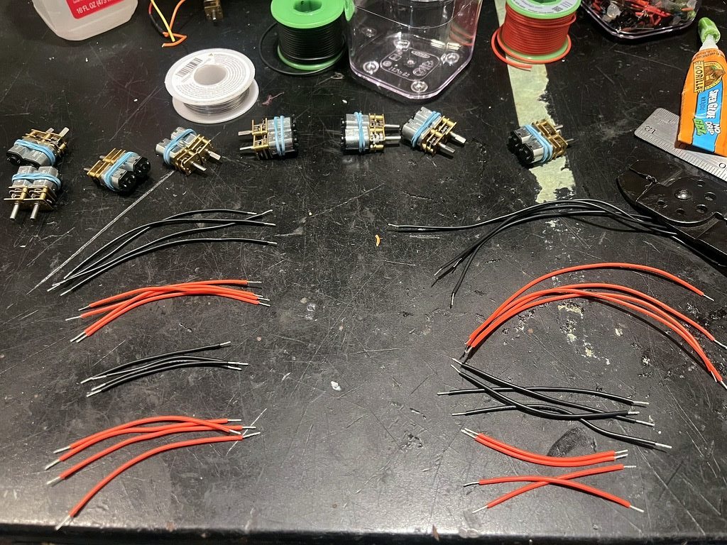 Motor leads cut and stripped to length beside gear motors